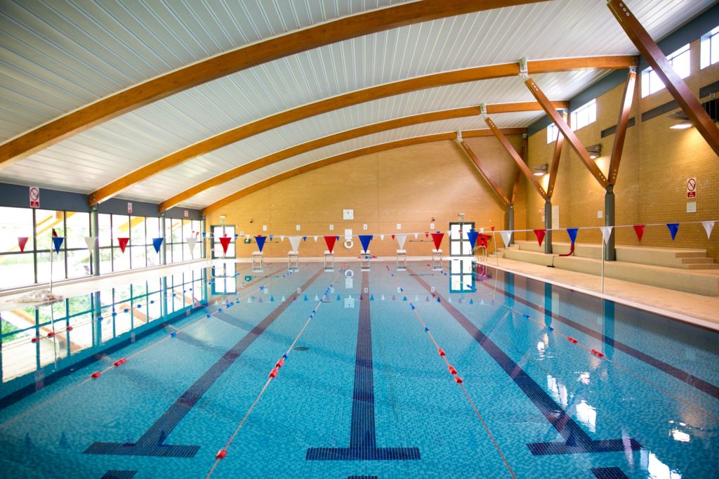 Olympic sized swimming pool with white, red, and blue bunting